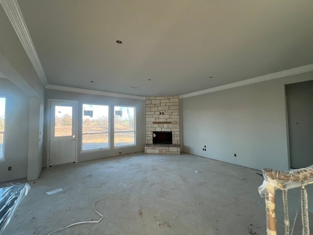 unfurnished living room featuring crown molding and a stone fireplace