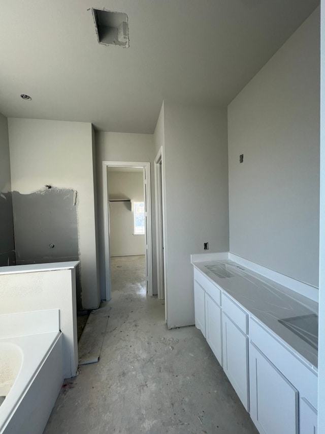 bathroom with a bathing tub and vanity