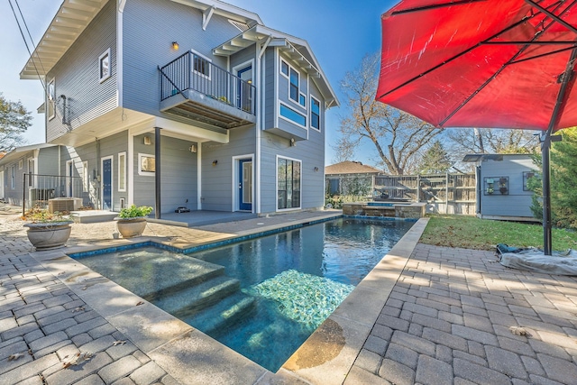 view of pool with a patio area and central AC unit