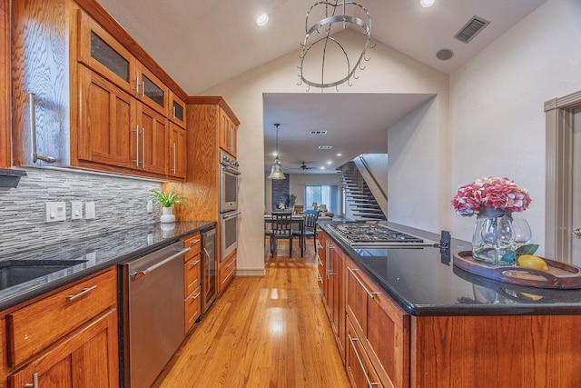 kitchen with ceiling fan, light hardwood / wood-style floors, lofted ceiling, and appliances with stainless steel finishes