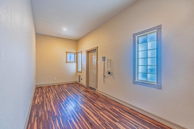 unfurnished room with dark hardwood / wood-style floors