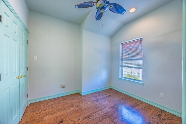 spare room featuring ceiling fan, hardwood / wood-style floors, and vaulted ceiling