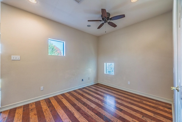 unfurnished room with a wealth of natural light, ceiling fan, and dark wood-type flooring