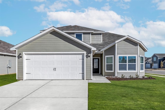 view of front of property with a garage and a front lawn