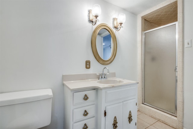 bathroom with tile patterned floors, vanity, a shower with shower door, and toilet