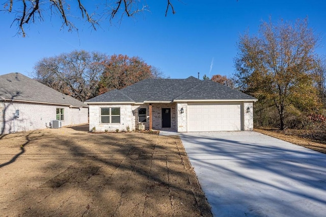 view of front of house featuring central AC unit and a garage