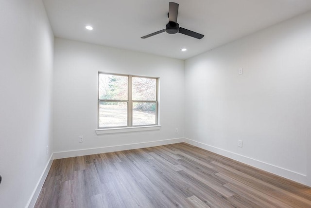 empty room featuring ceiling fan and light hardwood / wood-style floors