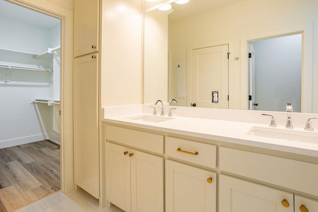 bathroom with vanity and hardwood / wood-style flooring