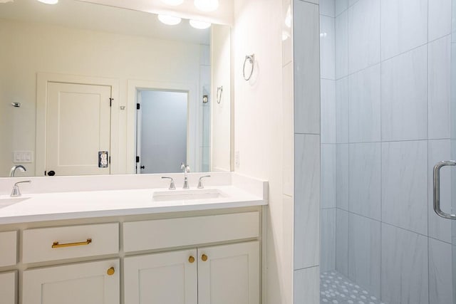 bathroom featuring vanity and an enclosed shower