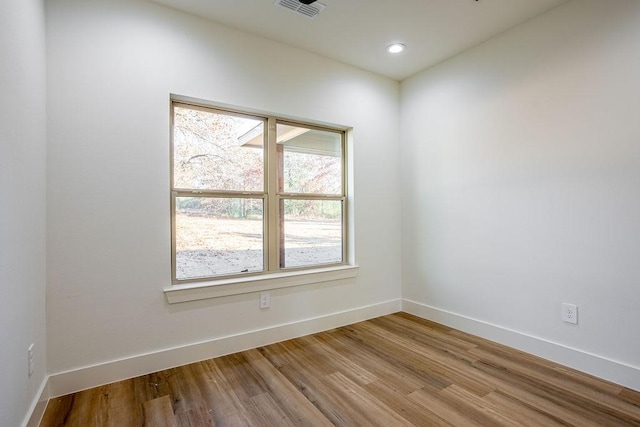 empty room with light hardwood / wood-style flooring