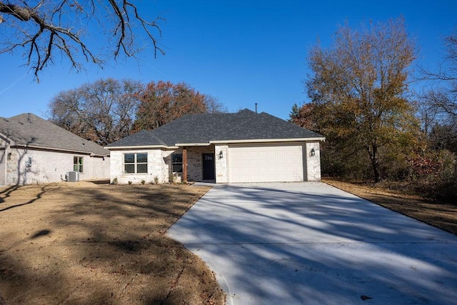 view of front of house featuring a garage and central air condition unit