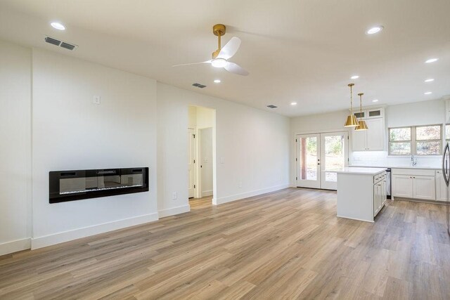 kitchen featuring white cabinetry, ceiling fan, light hardwood / wood-style floors, and decorative light fixtures