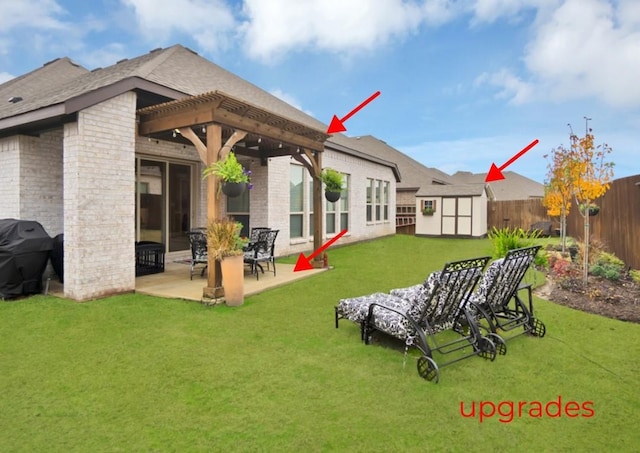 rear view of house with a storage shed, an outbuilding, brick siding, a fenced backyard, and a patio