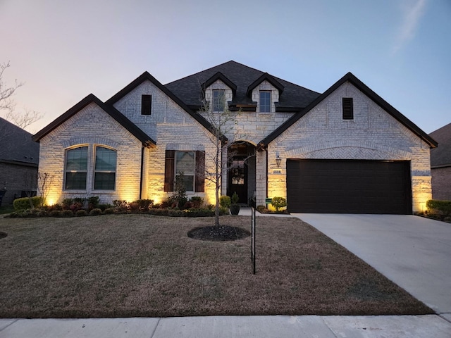224 Chesapeake Dr, Forney, TX 75126 - french country inspired facade featuring driveway, a garage, brick siding, a front yard, and stone siding