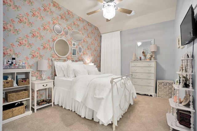 carpeted bedroom with a ceiling fan and wallpapered walls