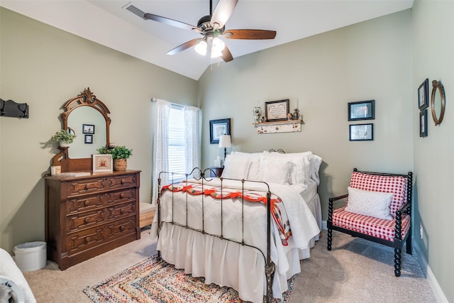 carpeted bedroom with visible vents, a ceiling fan, baseboards, and lofted ceiling