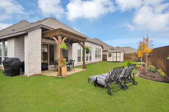 back of property with a storage shed, an outbuilding, a patio area, brick siding, and a fenced backyard