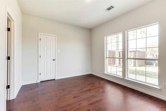 unfurnished room featuring dark hardwood / wood-style flooring