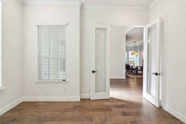 unfurnished room featuring crown molding, dark hardwood / wood-style flooring, and french doors