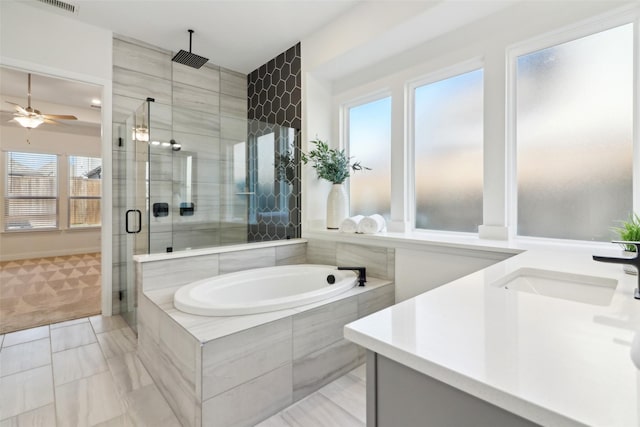 bathroom featuring vanity, shower with separate bathtub, and tile walls