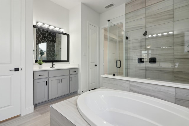 bathroom featuring vanity, ceiling fan, a wealth of natural light, and separate shower and tub