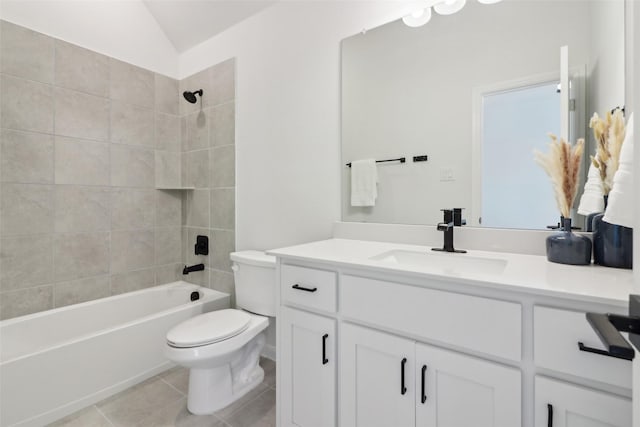 full bathroom featuring tiled shower / bath combo, vanity, toilet, and tile patterned flooring