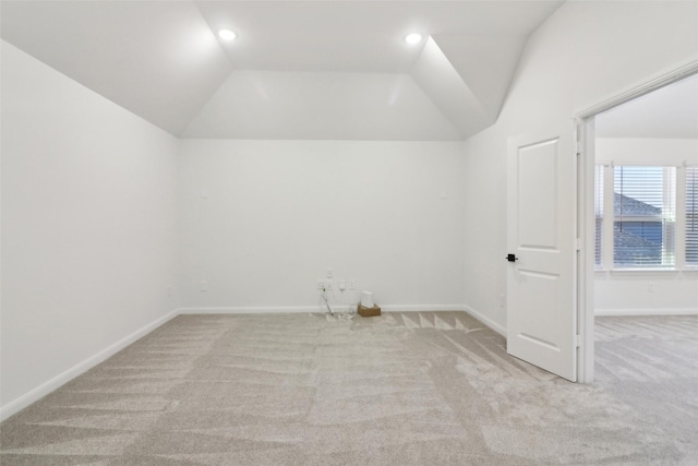 carpeted spare room with ceiling fan and lofted ceiling