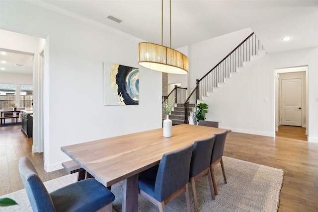 dining area featuring ornamental molding and dark hardwood / wood-style floors