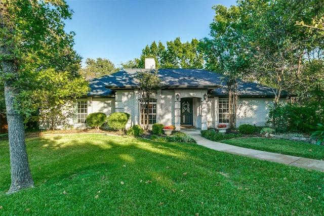 ranch-style home with a front lawn