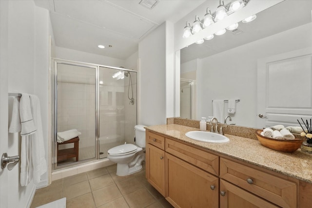 bathroom featuring vanity, a shower with shower door, tile patterned floors, and toilet