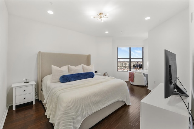 bedroom with dark hardwood / wood-style floors