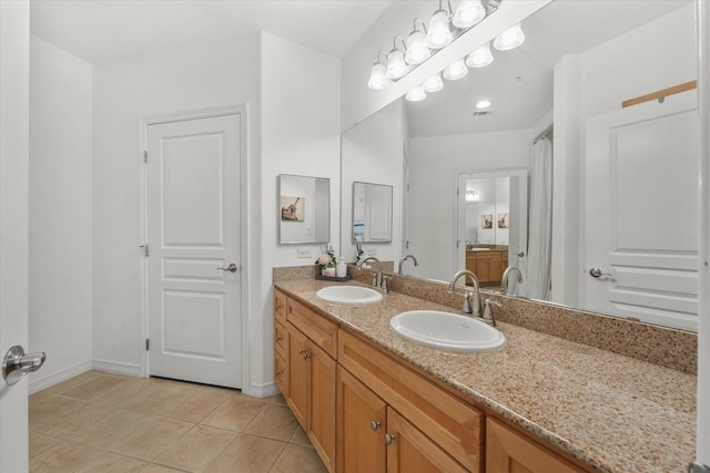 bathroom featuring tile patterned flooring and vanity