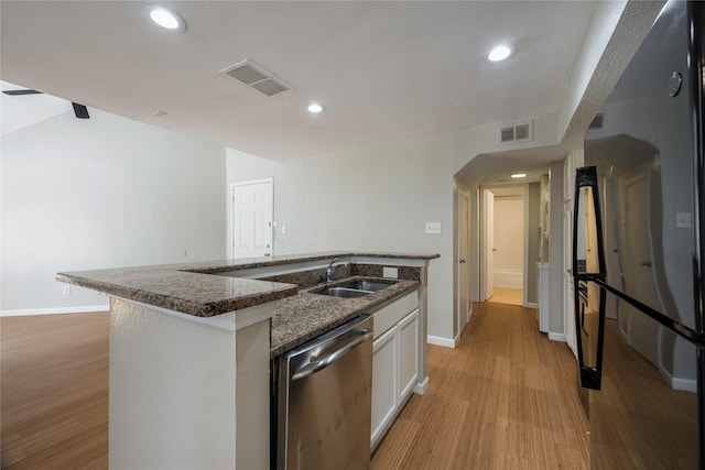 kitchen featuring white cabinetry, sink, light hardwood / wood-style flooring, stainless steel dishwasher, and a kitchen island with sink