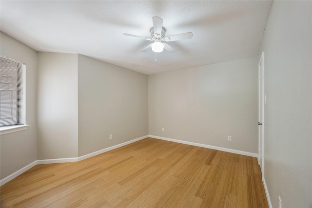 spare room featuring ceiling fan and light wood-type flooring