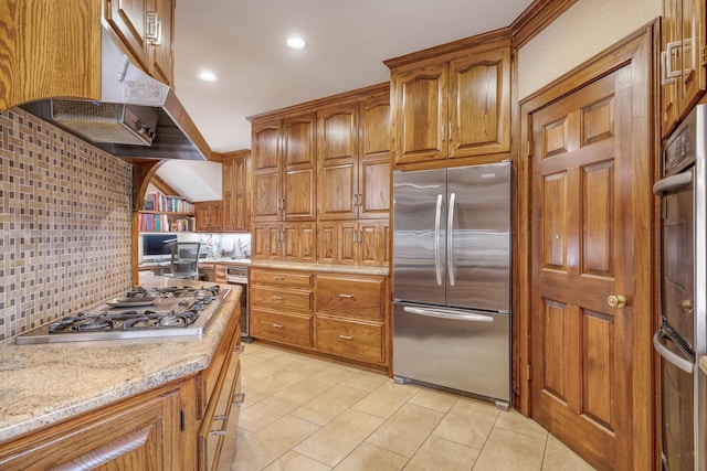 kitchen with decorative backsplash, stainless steel appliances, and light stone counters