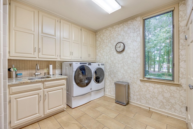 laundry room featuring cabinets, sink, light tile patterned floors, and washer and dryer