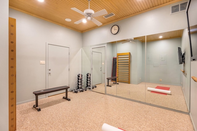 workout room featuring ceiling fan, wooden ceiling, and carpet floors