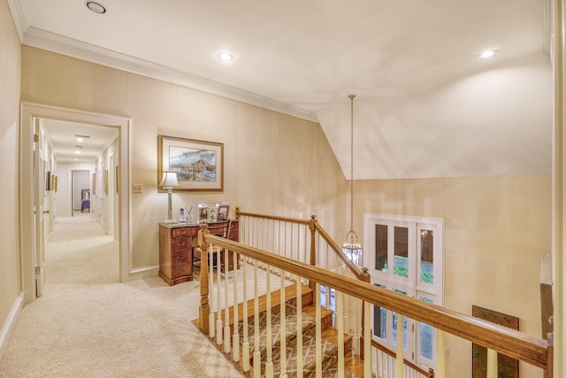 hallway featuring crown molding, light carpet, and vaulted ceiling