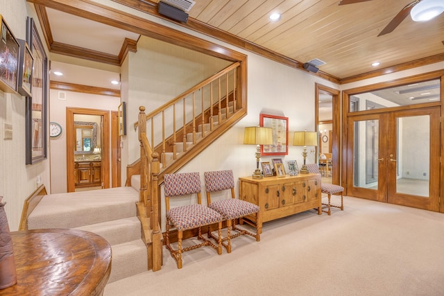 living area featuring french doors, carpet floors, ornamental molding, and wooden ceiling