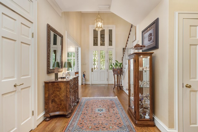 entryway with a chandelier and hardwood / wood-style flooring