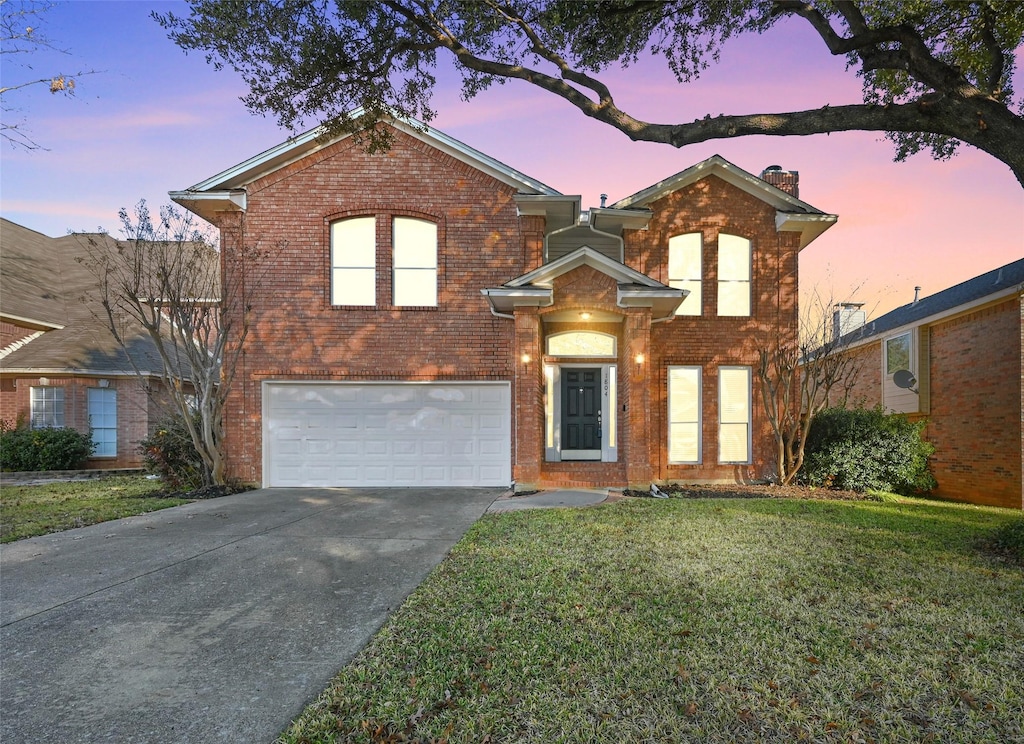 view of front of property with a garage and a front yard