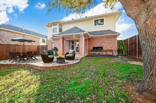 rear view of property with a lawn and a patio area