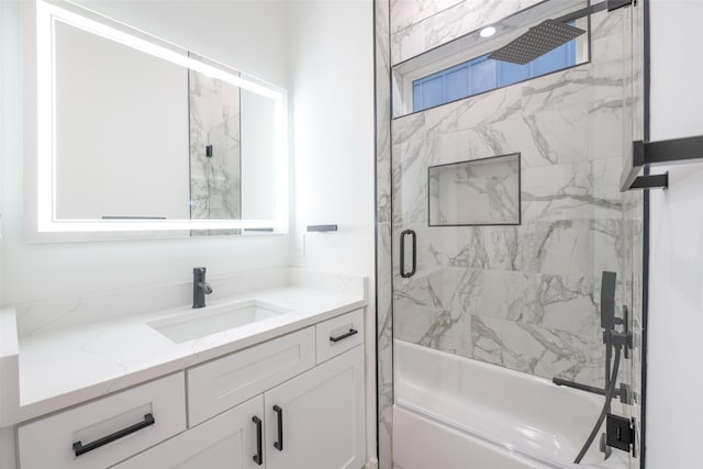 bathroom featuring bath / shower combo with glass door and vanity