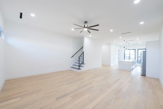 unfurnished living room featuring light hardwood / wood-style floors and ceiling fan