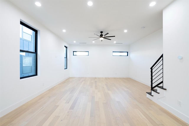 empty room featuring ceiling fan and light hardwood / wood-style floors