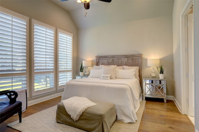 bedroom featuring ceiling fan, light hardwood / wood-style flooring, and vaulted ceiling