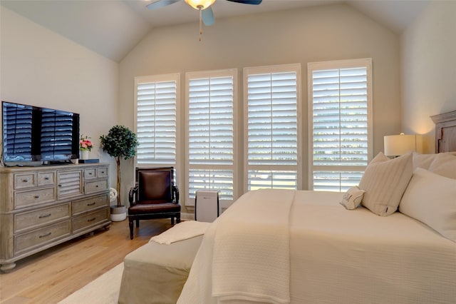 bedroom featuring light hardwood / wood-style floors, ceiling fan, and lofted ceiling