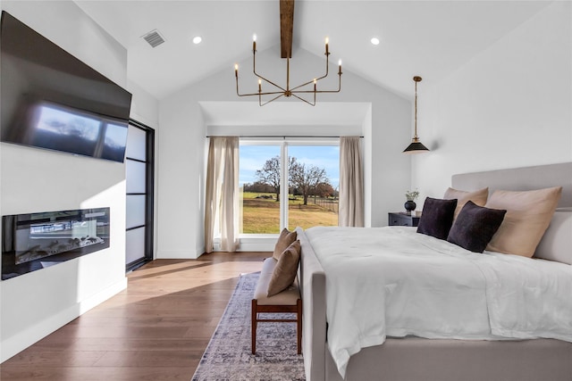 bedroom with visible vents, lofted ceiling with beams, wood finished floors, a chandelier, and baseboards