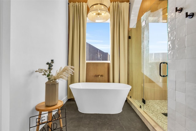 bathroom featuring a soaking tub, a shower stall, and tile patterned flooring