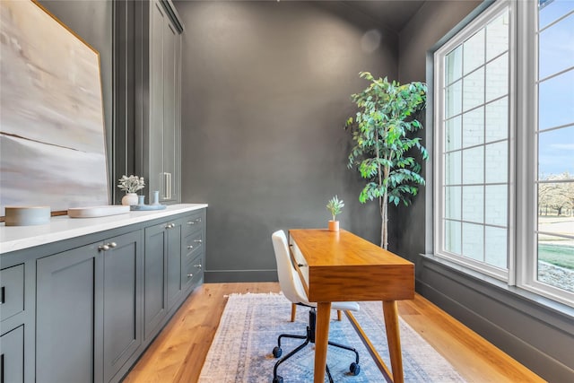 office with light wood-type flooring and baseboards